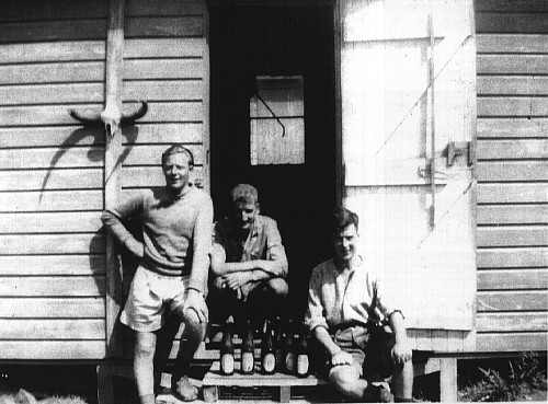 Three blokes about to do some hard work emptying bottles